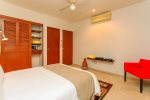 The master suite with double bed, en suite bathroom, pool view and private balcony access